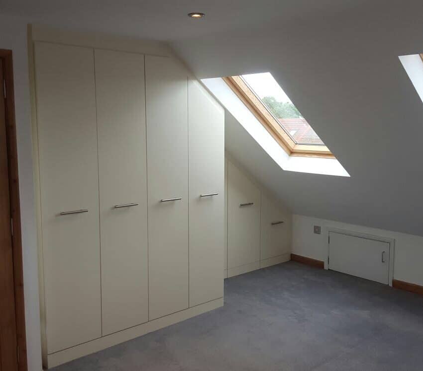 Cream fitted wardrobes in a loft room