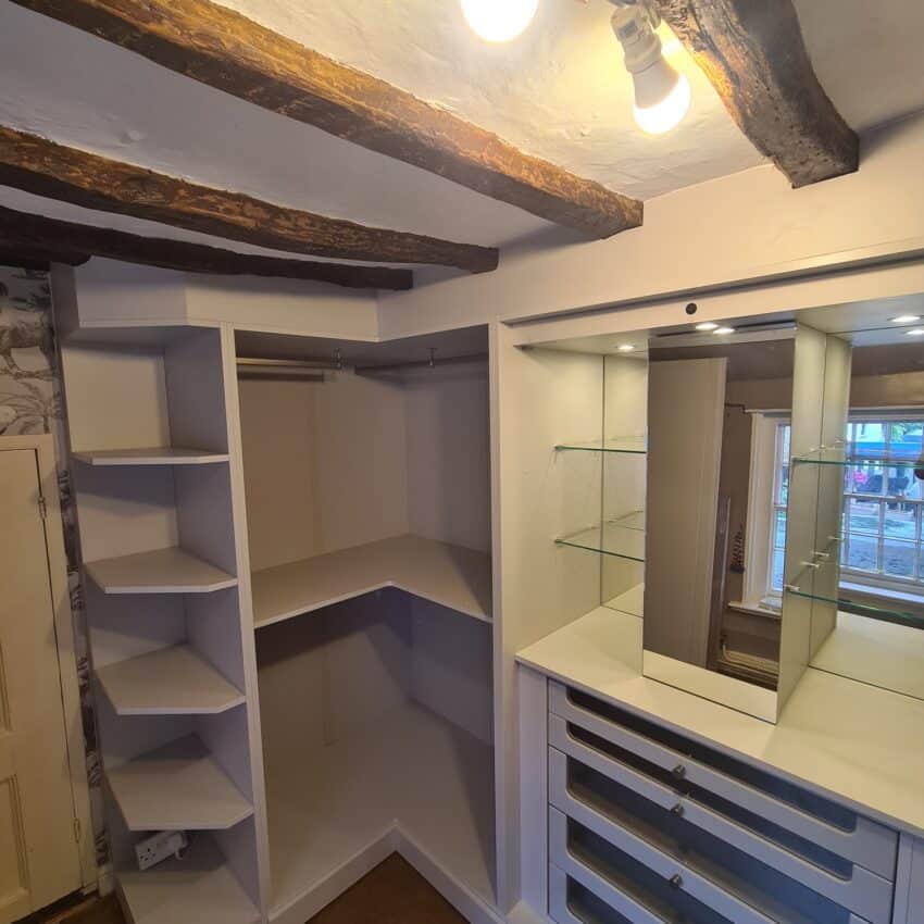 Customised fitted wardrobes in a 17th century cottage with beams